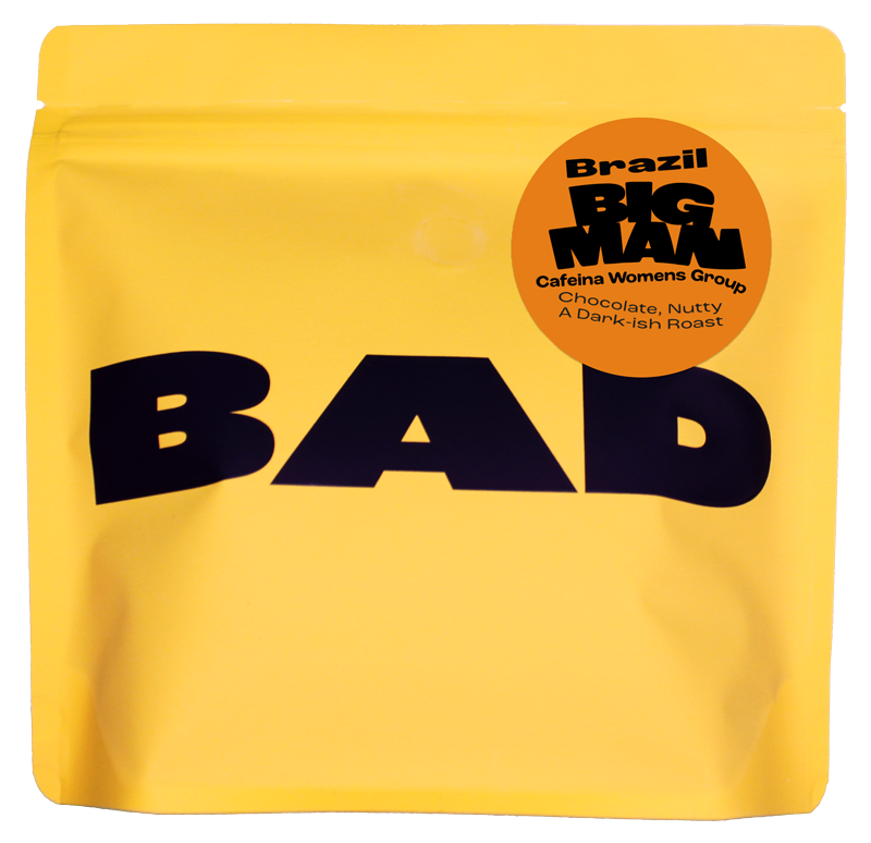 Yellow specialty coffee bag with 'BAD' text and 'Big Man' label "cafeina Womens Group, Brazil"
