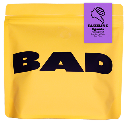 Yellow coffee bag with 'BAD' text and a purple label on a white background