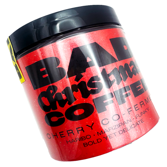 Red container with black text labeled 'Bad Christmas Coffee' Cherry Co-Ferment