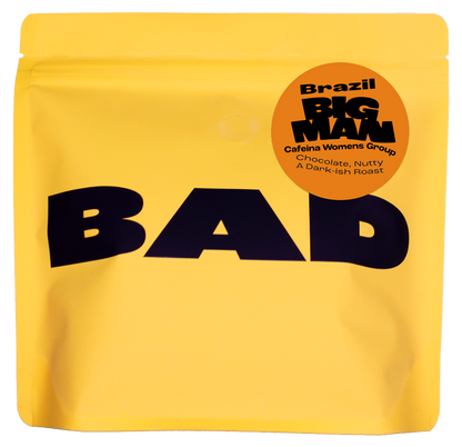 Yellow specialty coffee bag with 'BAD' text and 'Big Man' label "cafeina Womens Group, Brazil"