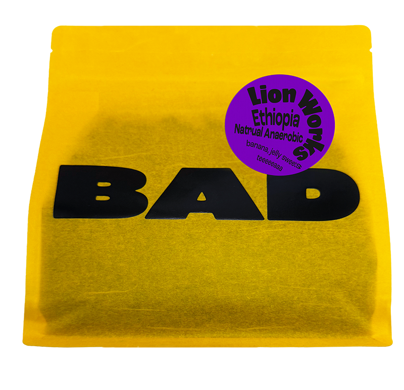 A bright yellow pouch of Lion Works Natural Anaerobic coffee from Ethiopia, with taste notes of jelly sweets, bananas and tea. From Bad Coffee.