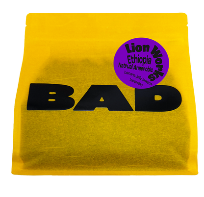 A bright yellow pouch of Lion Works Natural Anaerobic coffee from Ethiopia, with taste notes of jelly sweets, bananas and tea. From Bad Coffee.